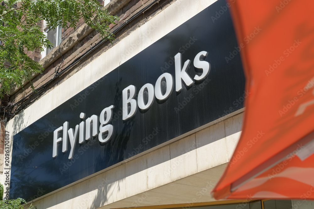 Obraz premium exterior building facade and sign of Flying Books, a book store, located here at 784 College St, Toronto