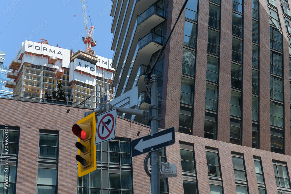 Obraz premium contrast of FORMA Toronto condominium complex (designed by Frank Gehry) and PJ Condos (99 John St) designed by Hariri Pontarini Architects