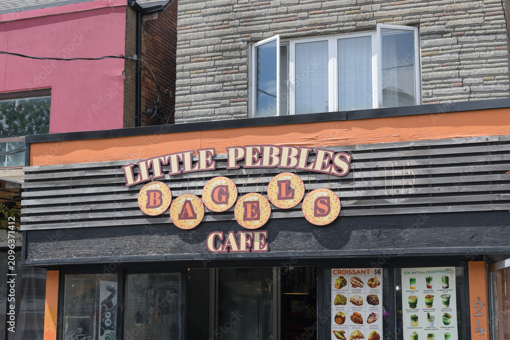 Obraz premium exterior building facade and sign of Little Pebbles Cafe, located at 160 Baldwin St, in Kensington Market, Toronto