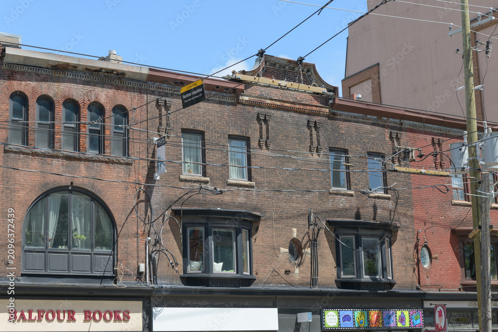 Obraz premium historic commercial block buildings including sign of Balfour Books, located at 468 College St, Toronto