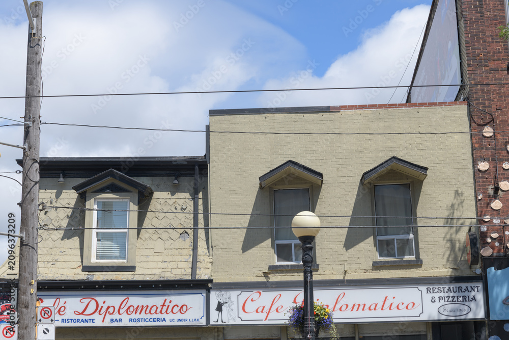 Obraz premium exterior building facade and sign of Cafe Diplomatico Restaurant & Pizzeria located at 594 College St, Little Italy, Toronto
