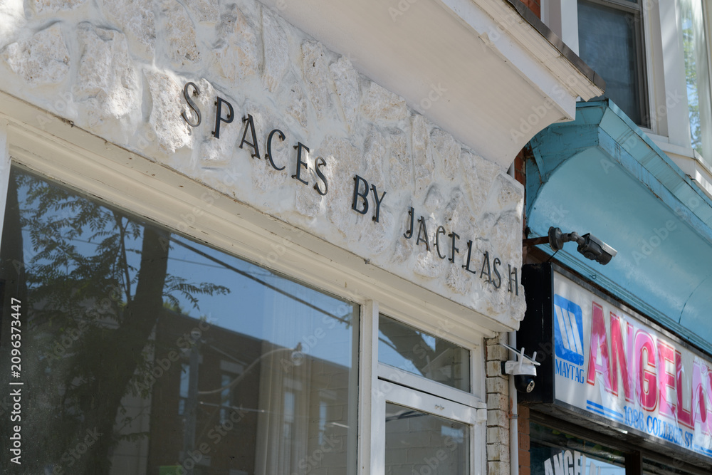 Obraz premium exterior building facade and sign of Spaces by Jacflash, an interior designer, located at 1088 College St, Toronto