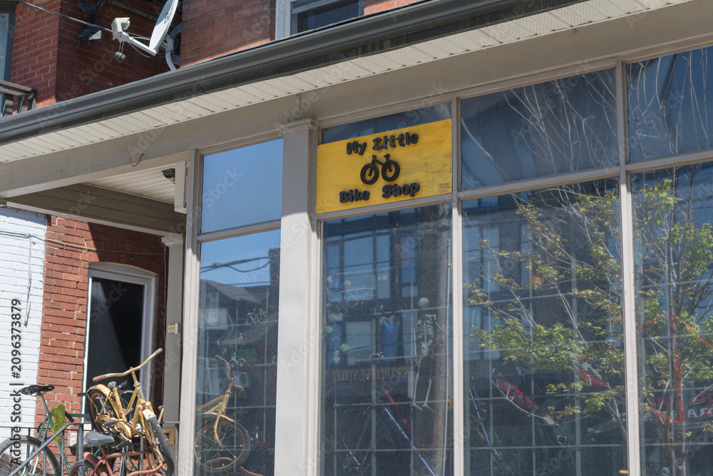 Obraz premium ghost (?) sign on the facade of My Little Bike Shop located at 882 College St, Toronto