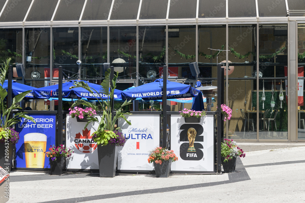 Obraz premium patio space outside The Pint Public House decked out with FIFA World Cup banners and signs including Soccer Canada and Michelob Ultra, 277 Front St W, Metro Convention Centre, Toronto