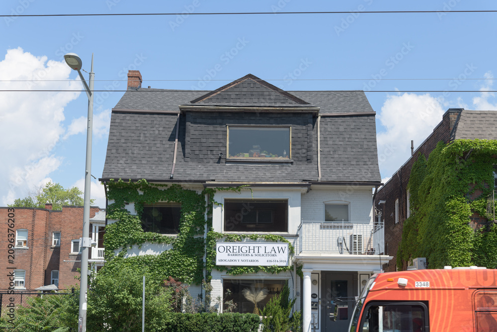 Obraz premium exterior building facade and sign of O'Reight Law located at 598 St Clair Av W, Toronto