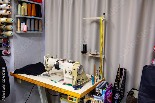 Konstfotografi Industrial sewing machine in a professional tailoring workshop with thread stand and sewing supplies