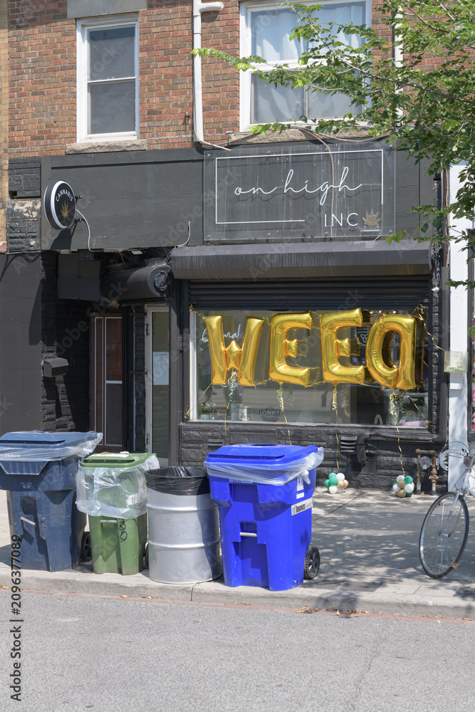 Obraz premium recycling bins on sidewalk outside On High Inc, a cannabis store, located at 806A St Clair Av W, Toronto
