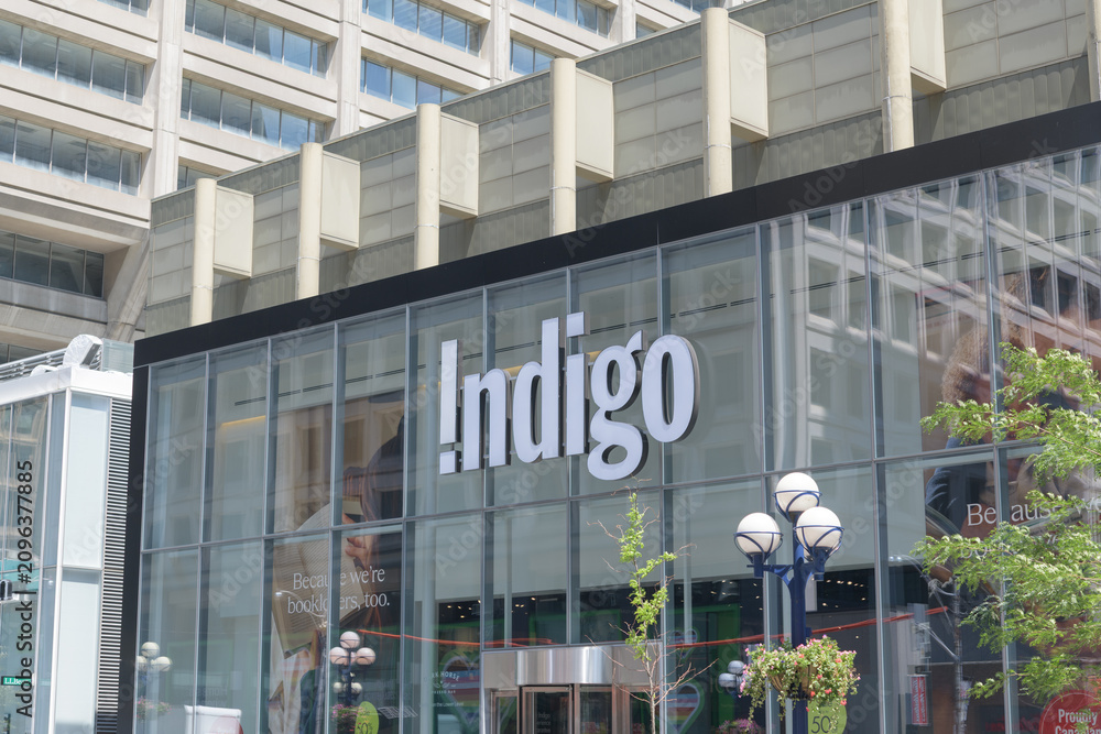 Obraz premium exterior building facade and sign of Indigo, a book store chain, located here at 55 Bloor St W inside Manulife Centre (Bay St side), Toronto