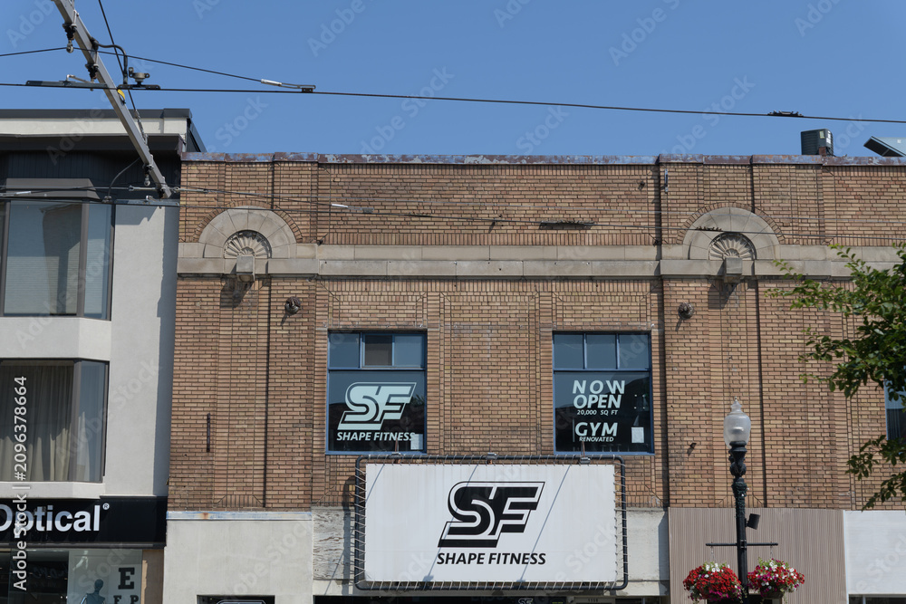 Obraz premium exterior building facade and sign of Shape Fitness located at 1156 St Clair Av W, Toronto (formerly St Clair Theatre, built 1921)