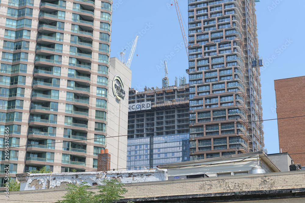 Obraz premium abstract view of a condominium, sign outside Chelsea Hotel, Concord Sky condo under construction, and 8 Elm Condos, Toronto