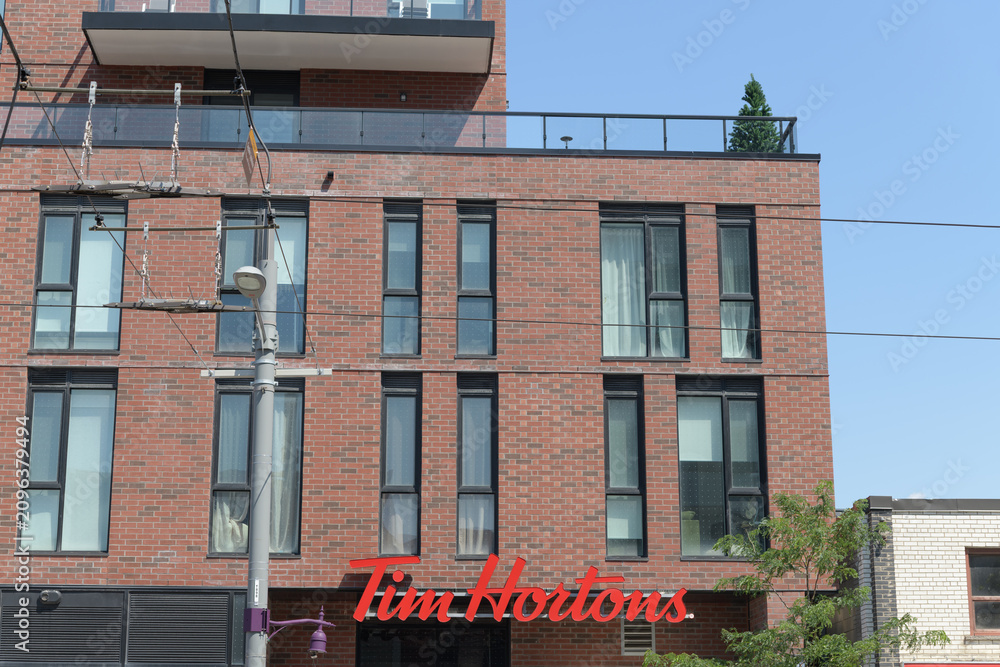 Obraz premium condo building and sign of Tim Hortons, a coffee shop chain, located at 900 St Clair Av W, Toronto