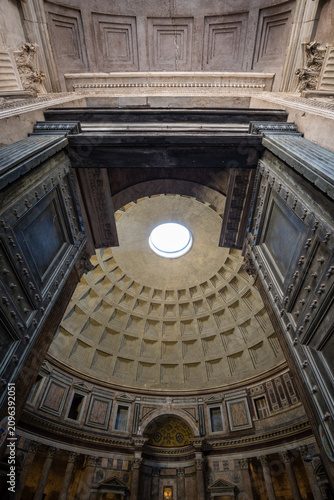 View through the giant ancient bronze doors into the interior and coffered dome of the Pantheon in Rome, Italy