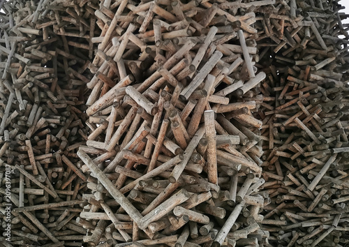 Pile of wooden sticks arranged in a textured, abstract formation