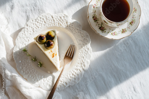 Flat Lay of Cheesecake and Black Tea on a White Table