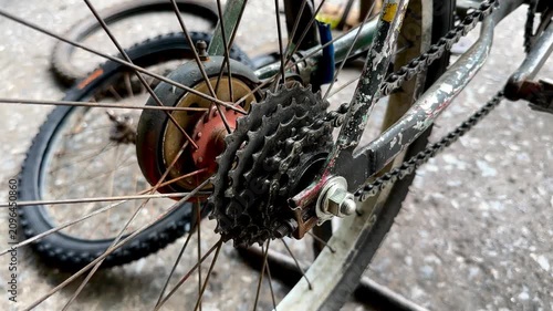 Close-up of a mechanic using a wrench to loosen the axle nut on a bicycle wheel.