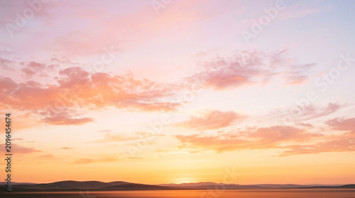 Beautiful Pink and Orange Pastel Sunset Over Mountains and Lake