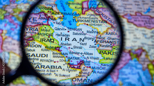 фотографія Close up of magnifying glass highlighting Iran and surrounding Middle Eastern countries