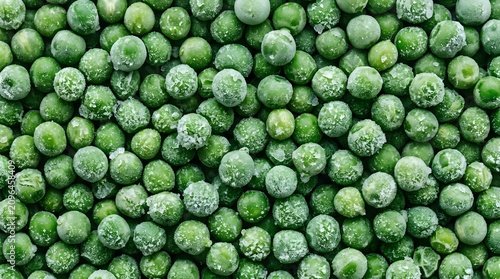 Frozen green peas are piled high in a large batch for storage