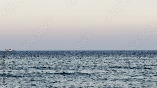 A boat sails on the sea. Cyprus Island, tourist boats, Mediterranean Sea.