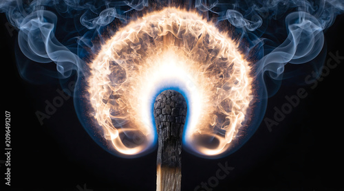 Extreme macro wooden match burning fiery smoke on black background