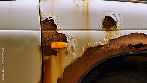Photography Car body corroding in Moscow, showing extensive rust damage and paint peeling