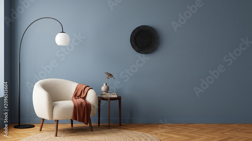 Modern Living Room Ambiance: A minimalist living room features a plush armchair, a sleek arc lamp, and a small side table adorned with decor, all set against a calming blue wall.
