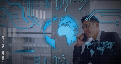 Phone call starting holo globe rotating while midadult Asian exec gesturing and showing global data