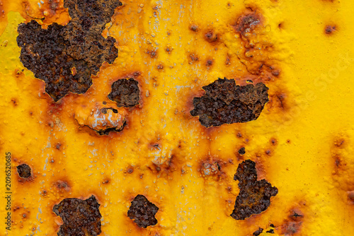 Obraz na plátne Rust on yellow painted iron caused by moisture. Texture