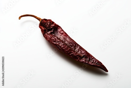 Dried guajillo chili on a clean white background with generous space for text