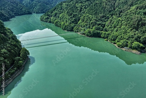 Photography Aerial drone photo of Ikawa Lake and suspension bridge in Shizuoka, Japan