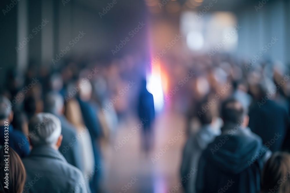 Fototapeta premium Blurred Audience at Event, Focused Light Source