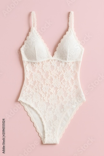 Elegant White Lace Bodysuit Lingerie on a Plain Backdrop