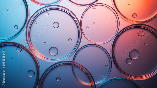 Top down view of multiple petri dishes with bubbles in vibrant blue with orange gradient lighting