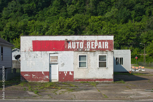 Abandoned Vintage Auto Repair Shop with Peeling Paint and Weathered Facade