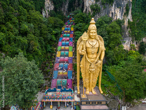 Photography Aerial view of iconic Lord Murugan statue and colorful stairs at Batu Caves in Kuala Lumpur, Malaysia