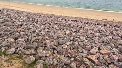 Coastal Stone Protection Against Beach Erosion.
Large stone barriers line the shoreline to reduce coastal erosion and protect beaches from the impact of waves, storms, and rising sea levels. These eng
