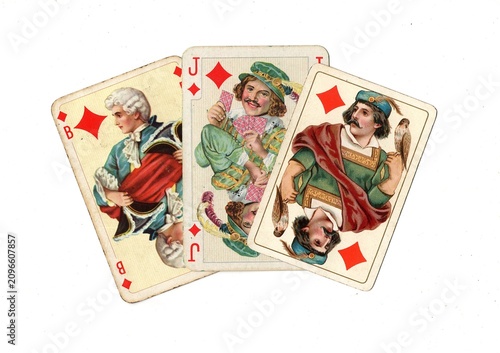 Photography A hand of three vintage picture playing cards in different designs isolated on a white background