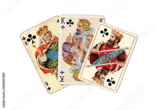 Photography A hand of three vintage picture playing cards in different designs isolated on a white background