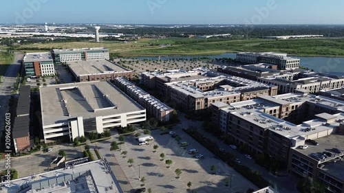 Brick clad corporate buildings mark edge of busy business development zone near major transit routes. Intelligent site planning maximizes available land for growth parking throughout Coppell, TX