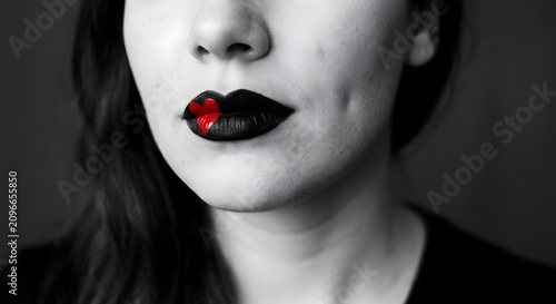 Woman wearing black lipstick with heart detail