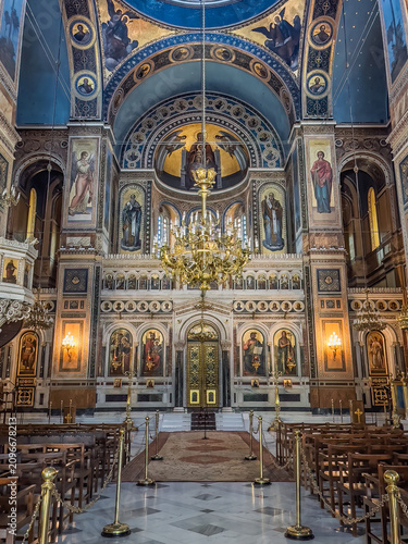 Athens, Greece - July 25, 2024: Holy Metropolitan Church of the Annunciation to the Virgin Mary. The large front wall of the basilica features a number of paintings and sculpted walls and pillars. The