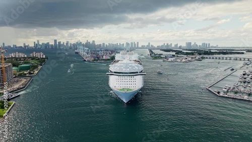 Aerial drone view of luxury liner. Ship leaving Miami beach port. Cruise ship vacation, 4k. Aerial view of cruise ship in vacation summer. Cruise ship vacation and travel at sea