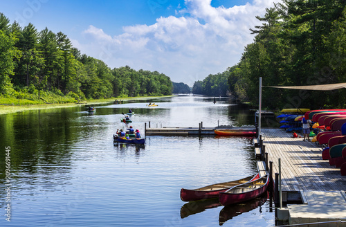 High-angle, wide-shot photograph capturing canoes on Ausable river, within Pinery Provincial park. The scene is full of vibrant colors and a sense of calm.
