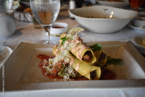 chicken taquitos on a white plate 