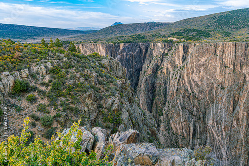 фотографія Sheer dark schist canyon walls plunge into the narrow gorge with Painted Wall pegmatite streaks visible, Black Canyon of the Gunnison NP, Colorado