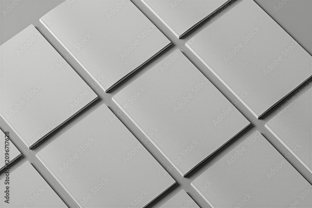 Obraz premium Top view of multiple blank white magazine covers arranged in grid layout on grey background. Clean minimal mockups provide space for graphic design branding presentation. Pro stationery display shows