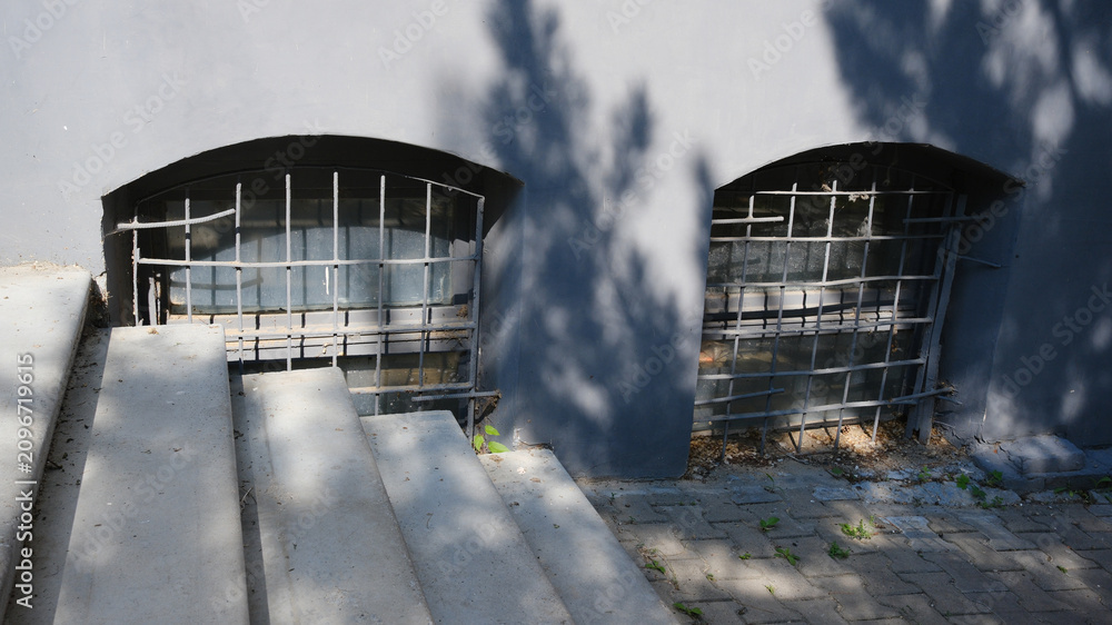 Αυτοκόλλητο A small window with a grate at ground level in the building, similar to a basement ventilation hole