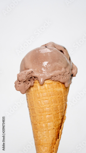 Vertical Close-up delicious chocolate ice cream in waffle cone isolated on white background.