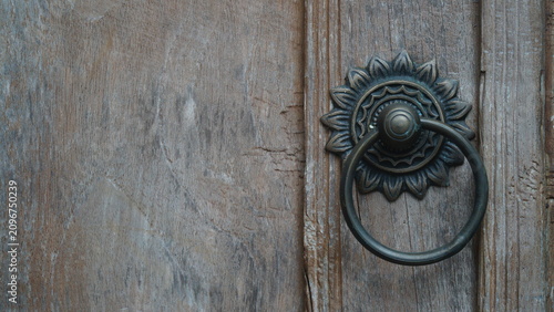 Fotografie Antique Brass Sunflower Door Knocker on Old Wood with Copy Space