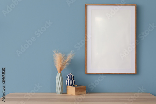 Empty wooden frame on a blu...